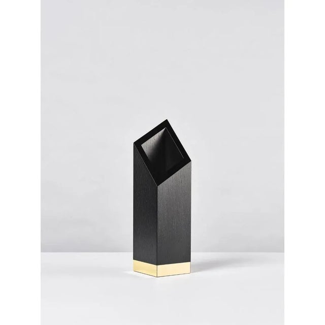 Babel vase sculpted by Lupo Horio¯kami Dimensions: D 15 x W 15 x H 55 cm Materials: Black ashwood, gold metallic foil “The...