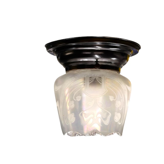 Lovely Iridescent semi flush light on an antique brass fitter-canopy. Etched design in a floral inspired art nouveau...