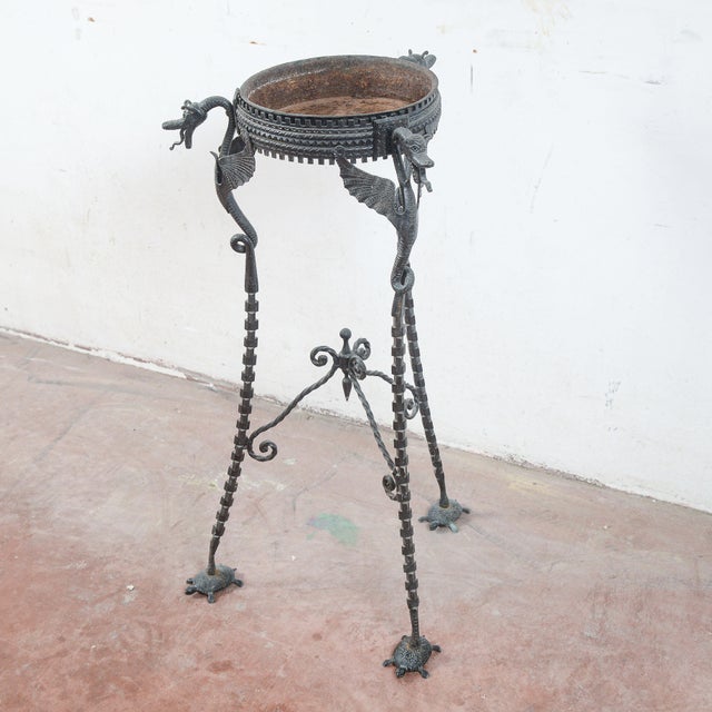This extraordinary antique trestle represents a superb example of the artistic craftsmanship of wrought iron....