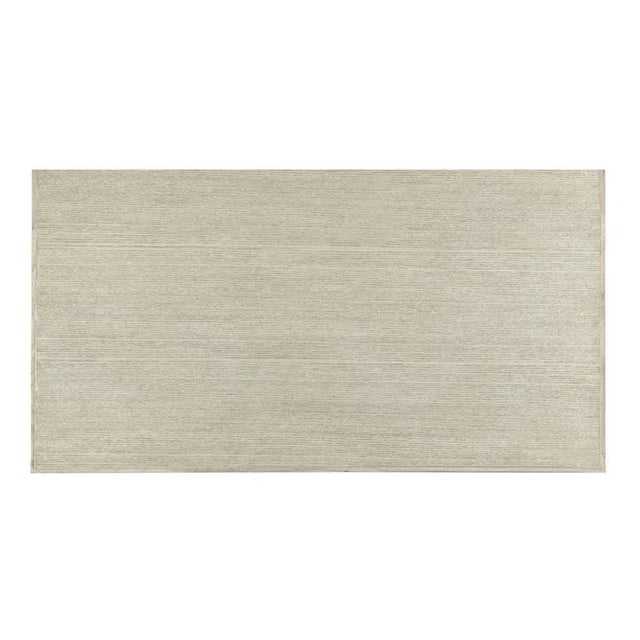 A rectangle top is placed over three individual storage drawers that are mounted with custom brass hardware. The chest is...