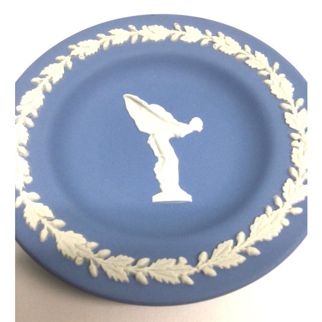 Rare, classic blue jasper Wedgewood tray featuring the Spirit of Ecstasy in cream. Comes with the original box. 4 1/2" x 1/2"