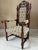 A striking mid-19th-century French carved walnut open armchair in the Louis XIII hunting style, dating to approximately...