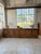 A vintage sideboard, reminiscent of a counter or kitchen island, dating back to the 1950s, with its rustic country house...