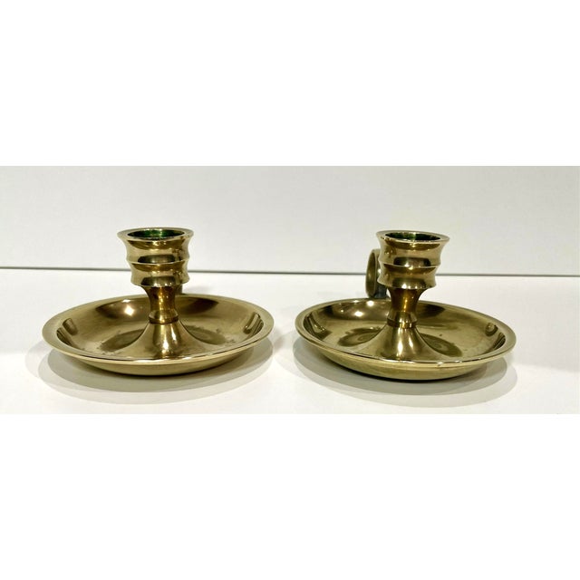 A pair of vintage brass chamberstick candle holders with finger loop. Each one weighs 5.4 oz.