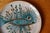 Let yourself be captivated by the hypnotic gaze of this fantastical fish! This magnificent decorative ceramic plate is an...