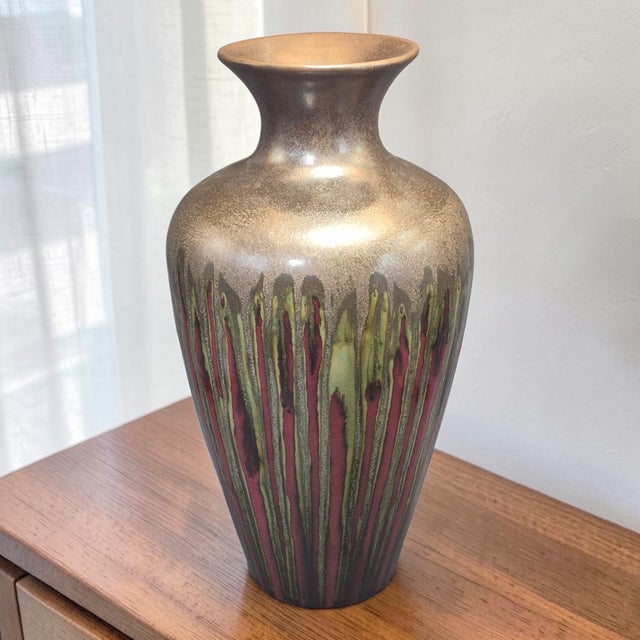 This vintage modern studio art drip glazed pottery vase stands at 16 inches tall and features a unique multicolor design....