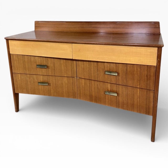 A beautifully proportioned mid-century sideboard by Lebus, showcasing refined British craftsmanship and elegant material...