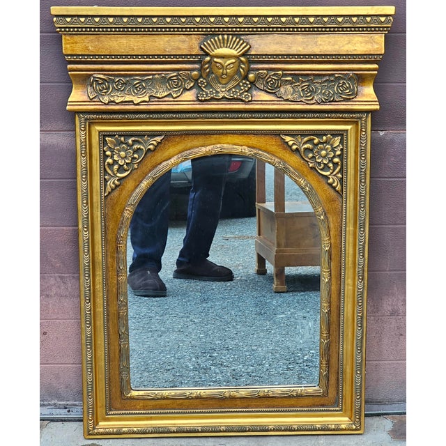 A late 20th century Hollywood Regency Italian Versace Style Gilded Medusa Figural Wall Mirror. Dimensions: 26.5" in width,...