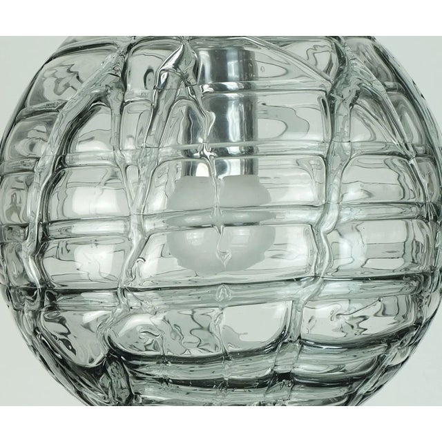 A very beautiful and elegant 1960s/70s pendant light by doria-leuchten, germany. Clear glass and smoke grey glass with a...