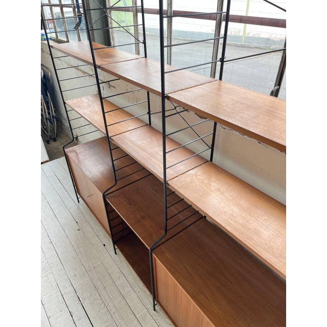A beautiful string shelving system from the german manufacturer whb. the containers and shelves are made of walnut and are...