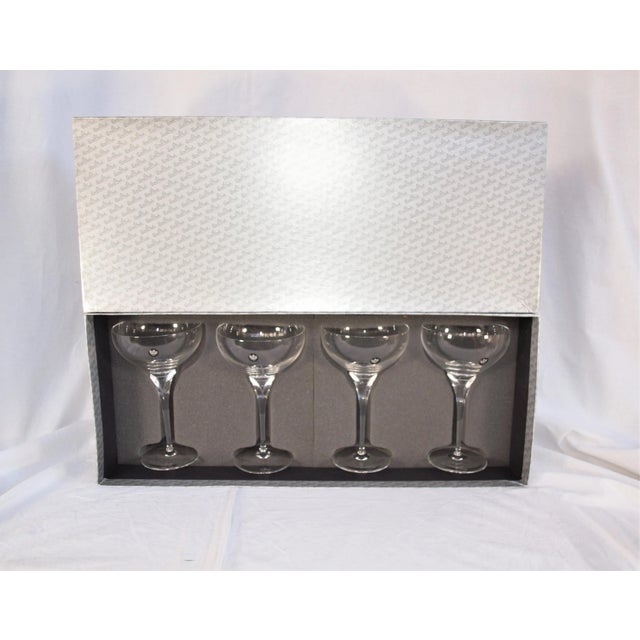 New in box set of four Rosenthal champagne glasses. Etched hallmark on bottom. Measures 7 3/8” high and 4 3/8” diameter...