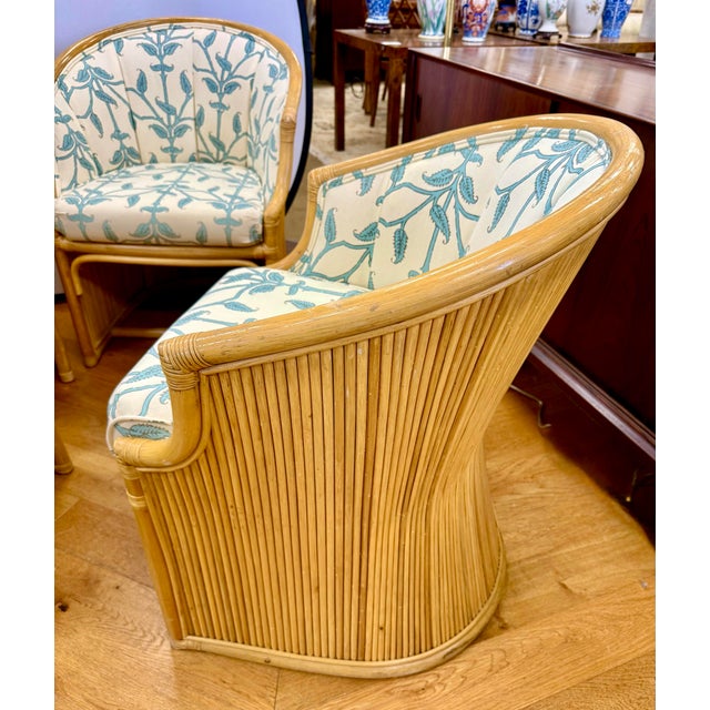 Stunning set of four vintage McGuire bamboo and split reed tub chairs. Each chair features a gracefully curved bamboo...