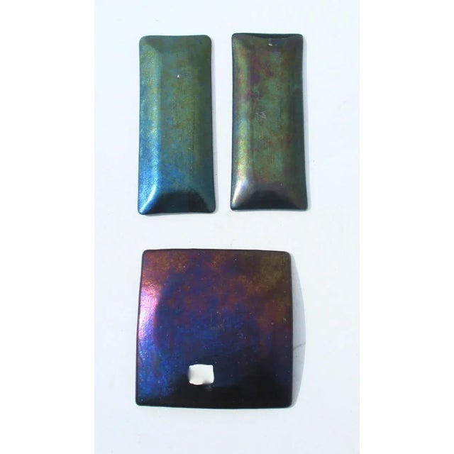 Three shallow trays in Dichroic glass, highly iridescence and beautifully designed. The two long trays are signed by KM...