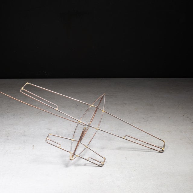 ABOUT A kinetic balance sculpture crafted from finely brazed copper finish or brass wire, this tabletop art piece depicts...