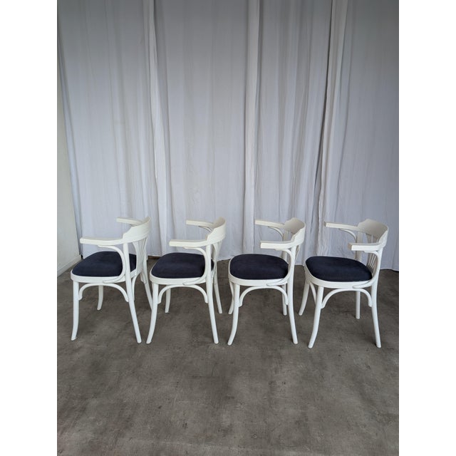 Set of 4 vintage wooden dining chair made in former Yugoslavia in the 1970s. The chair features elegant bentwood...
