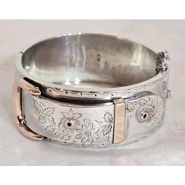 A distinctive Victorian sterling silver oval cuff bangle dating to 1885, designed in the decorative style of the Aesthetic...