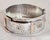 A distinctive Victorian sterling silver oval cuff bangle dating to 1885, designed in the decorative style of the Aesthetic...