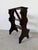 Elegant antique Italian library step stool crafted from solid dark mahogany wood, featuring a sculptural silhouette with...
