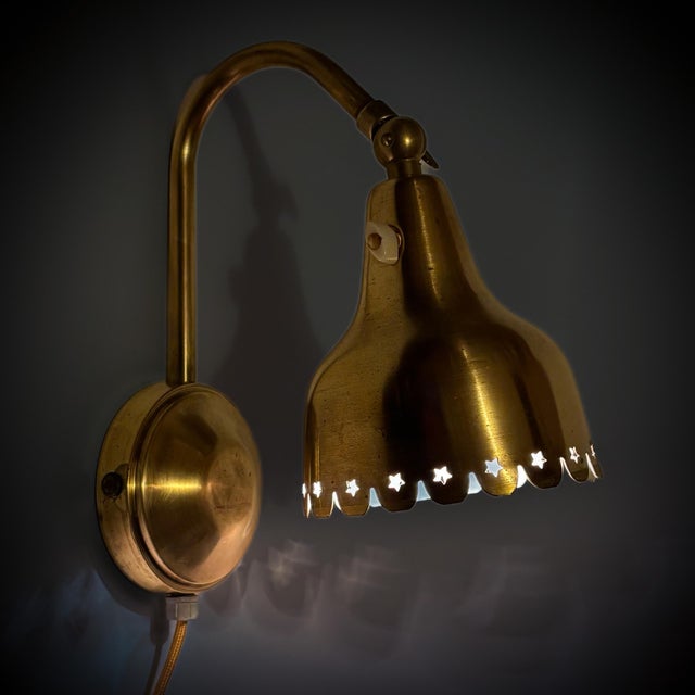 A beautiful Scandinavian wall lamp, produced by an unidentified Danish manufacturer in the 1940s. Crafted entirely from...