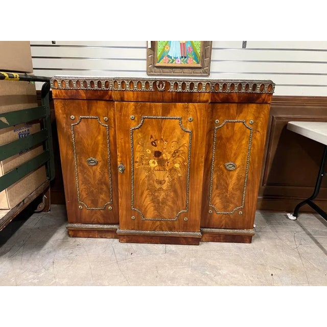 Early 20th century French Provincial Art Decor Style marble-top buffet made of rosewood, mahogany, and six other inlaid...