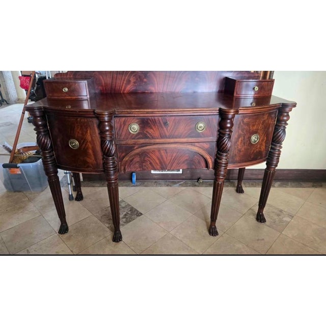 Henredon flame mahogany sideboard, buffet, or credenza featuring Empire style details such as carved paw feet and brass...
