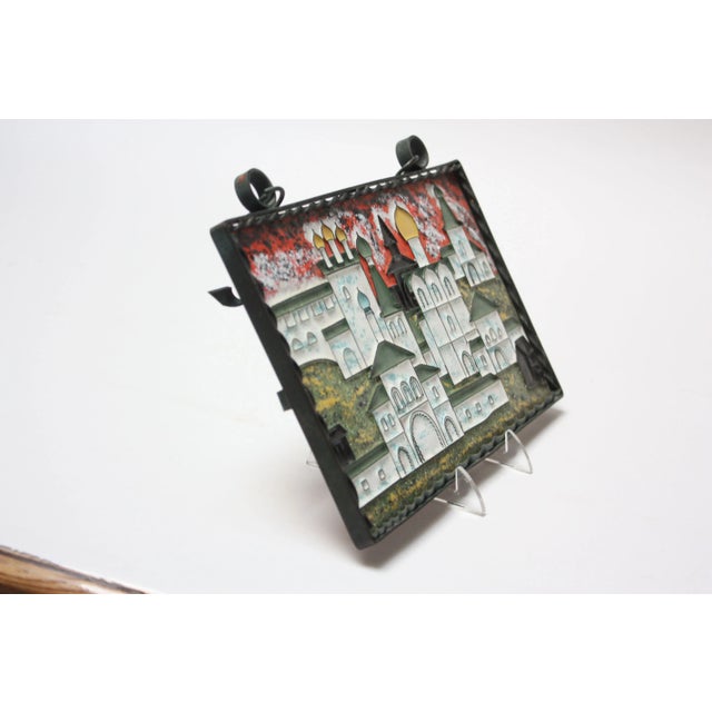 Charming Russian cityscape (ca. 1977) composed of an enamel on copper panel framed by a wrought iron bracket for wall-...