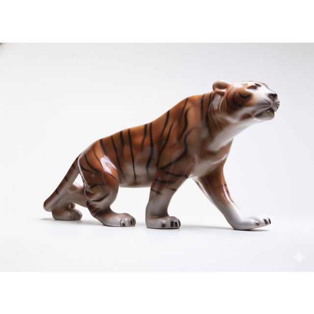 This hand-painted porcelain tiger was produced by Royal Dux in Czechoslovakia during the 1960s. The piece exemplifies...