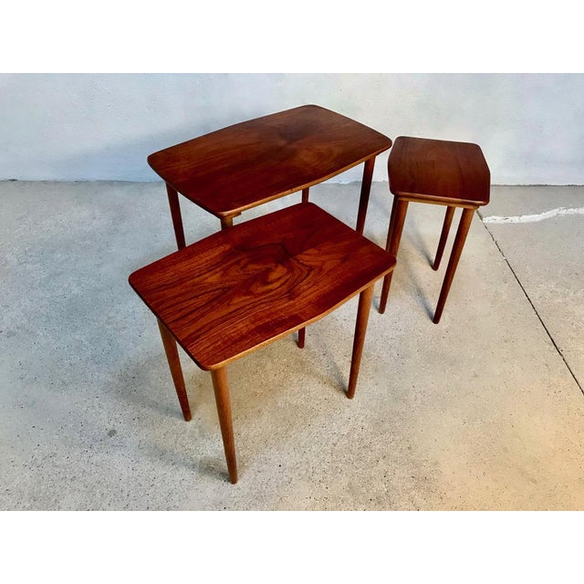 This high-quality set of three nesting side tables was manufactured in Denmark during the 1960s. It is made from solid and...