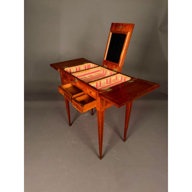 19th Century French Louis XVI style vanity with mirror, circa 1870, expertly crafted from mahogany with satinwood,...
