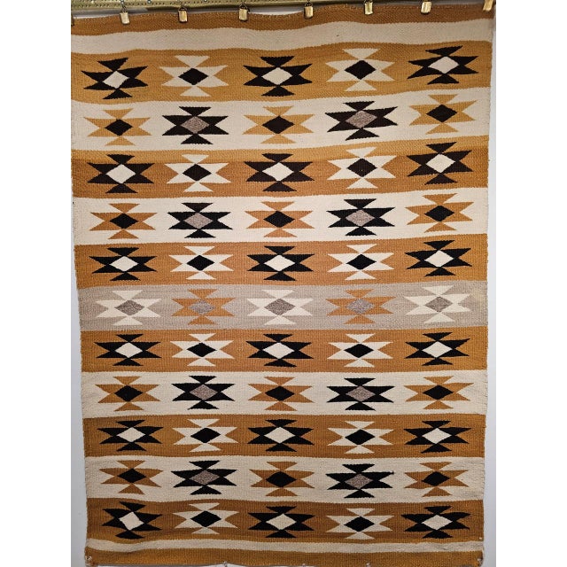 This exquisite vintage Navajo rug showcases a traditional Chinle Revival pattern, woven with hand-spun native wool in a...