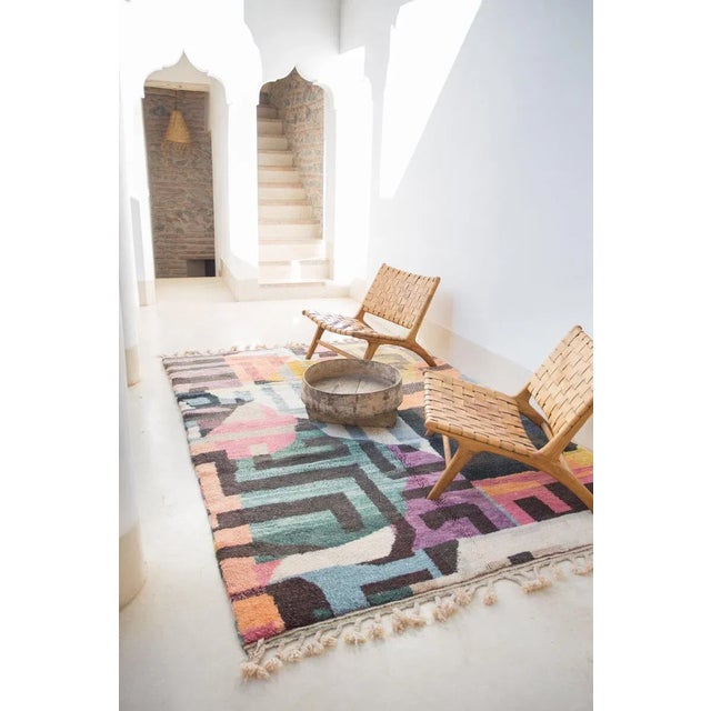 Bring any space to life with this beautiful and energetic 100% wool rug handmade in Morocco. Its abstract graphic design...