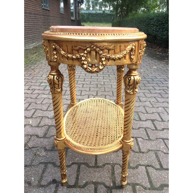 1970s French Louis XVI Gilt Beech Side Table with Pink Marble Top Introduce refined Parisian elegance into your interior...