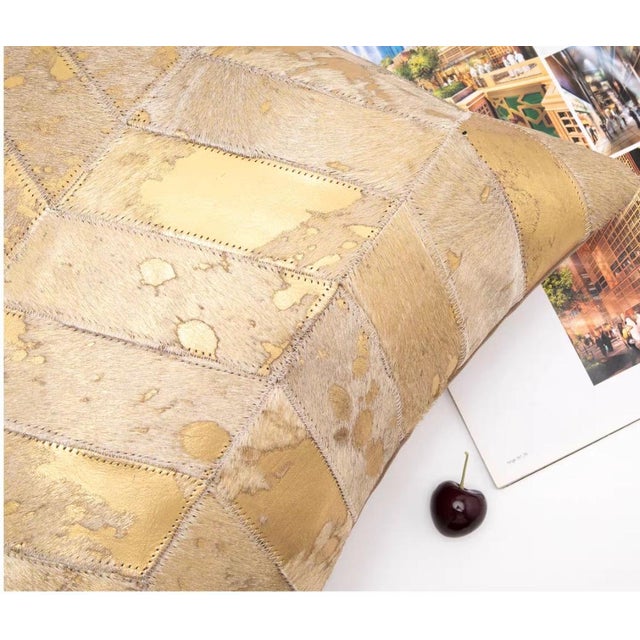 Rich leather-like patches in varying golden hues, stitched together for an artisanal, opulent look that defines rustic-...