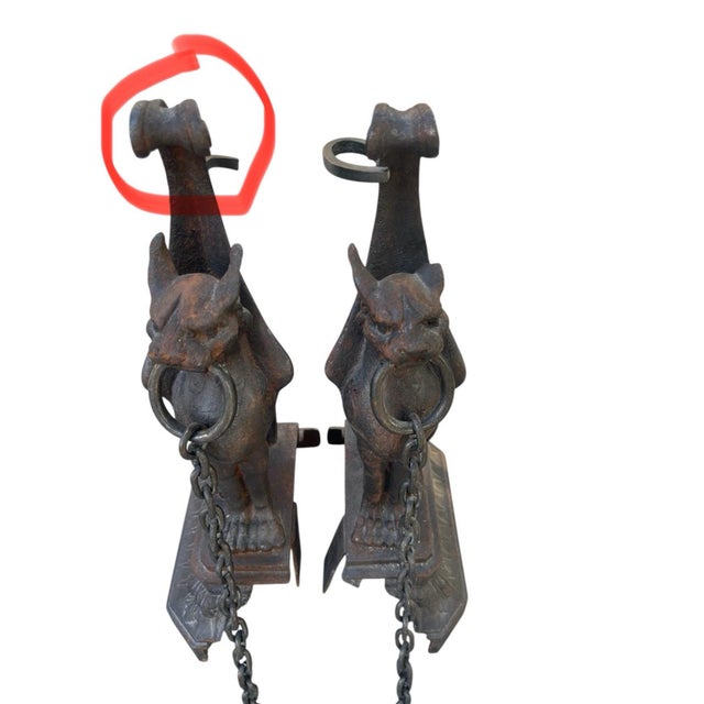 Striking pair of 19th-Century French cast iron fireplace andirons features beautifully detailed mythical...