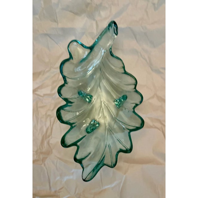This footed art glass bowl is in a lovely shade of pale green. It measures 13 3/4 in. long, 7 1/2 in. wide, and 2 7/8 in....