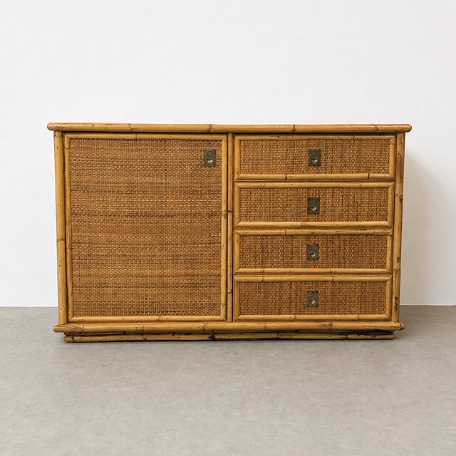 Vintage low sideboard in woven rattan with a bamboo-style structure and a warm natural honey tone. a decorative and...