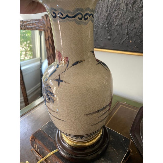 This petite lamp evokes a chinoiserie style and vintage Asian details. The pink and blue floral pattern is painted on a...