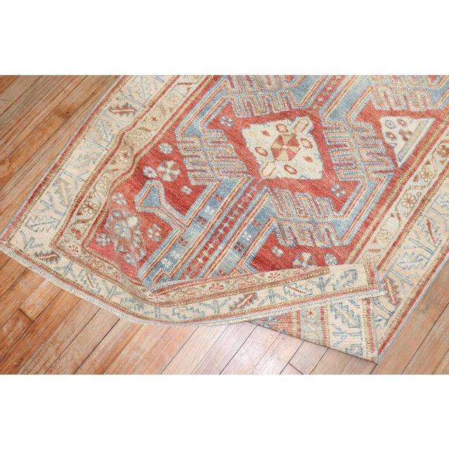 An early 20th Century Geometric Persian Malayer in red, blue and cream Measures: 3'6'' x 6'5''.