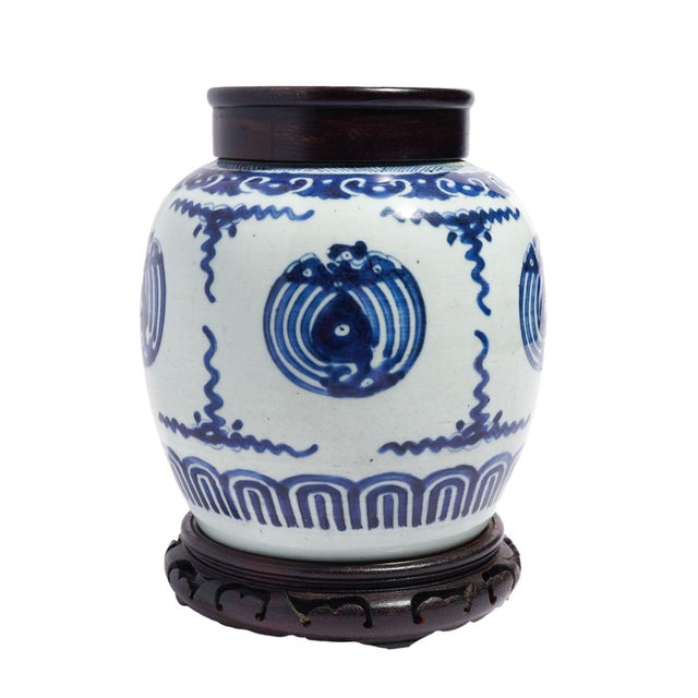 Porcelain ginger jar decorated in cobalt underglaze blue with a stylized Phoenix framed in scolloped cobalt borders, base,...