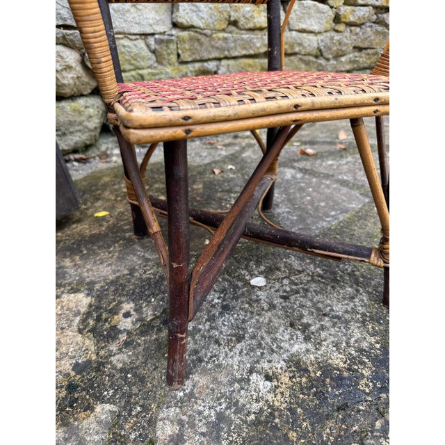 French rattan child’s chair with twig legs. 15”l x 13”d x 24”h 49-052