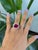A remarkable 12.04-carat Madagascar ruby glows in a deep, warm red at the centre of this solid two-tone 14K white and...