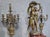 A spectacular three-piece mantel clock set, comprising a large clock with a sculpted group and two matching candelabra, in...