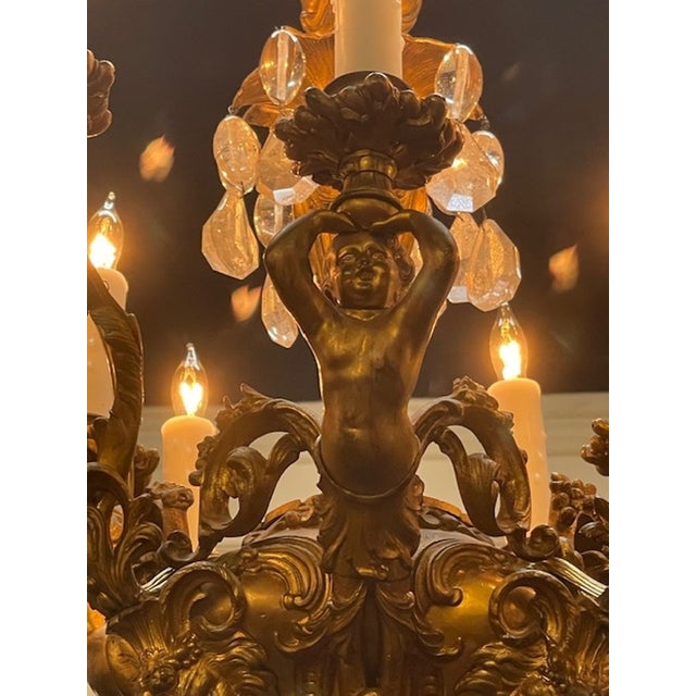 This 19th-century French gilt bronze and crystal chandelier with cherubs exudes elegance and charm. The craftsmanship and...