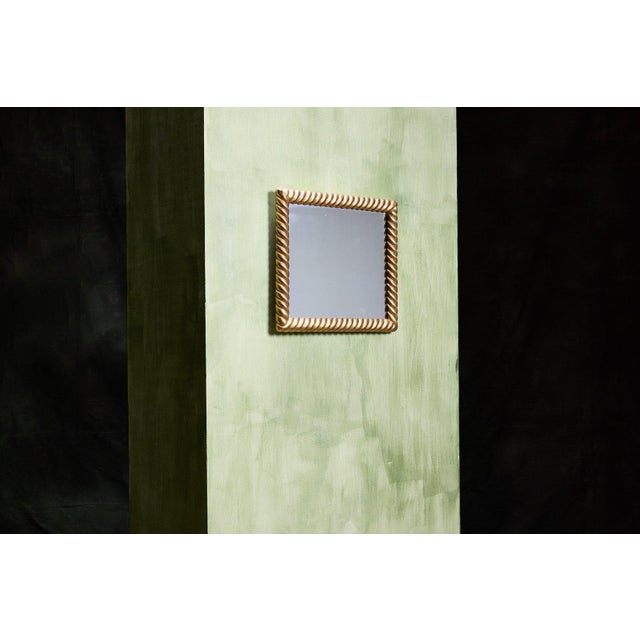 This is a vintage French braided gilt mirror featuring a thick, twisted rope-style frame finished in gold gilt. The mirror...
