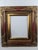 This is a substantial, highly decorative frame with a rich red finish accented by antique gold gilt tones. The wide...