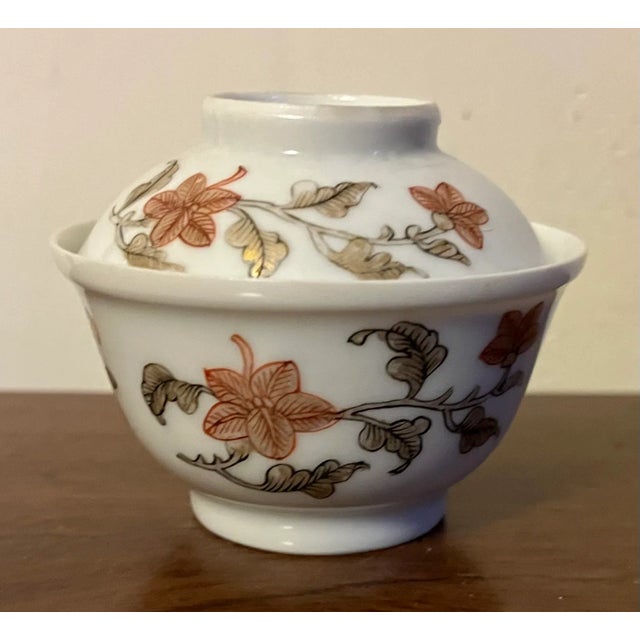 Antique 18th century Chinese export porcelain tea bowl and cover. Decorated with flowering vines in shades of iron red and...