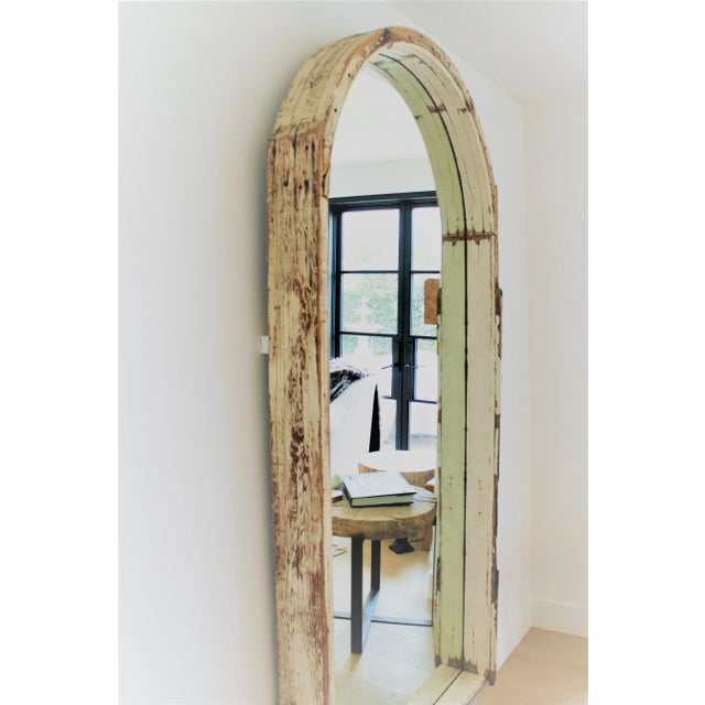 One-of-a-kind 1930's carved arched hardwood wall Mirror. This custom antique mirror is substantial in size and impact,...