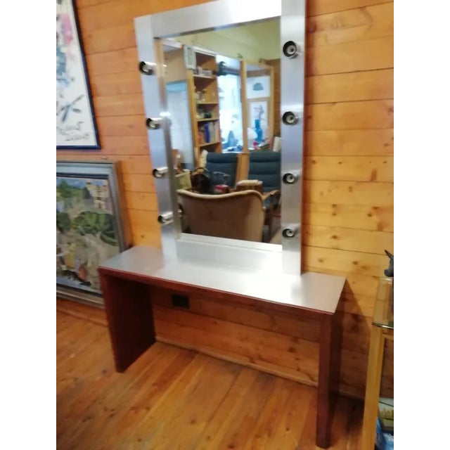 Petineuse mirror plus console table 1950s. Foil covered wood mirror with eight lights. Integrated switch. Original ceramic...