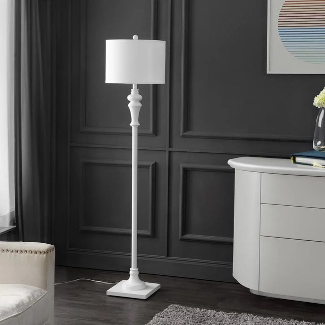 Illuminate your space with the Norla Floor Lamp. This striking white floor lamp combines a sleek metal body with a subtle...