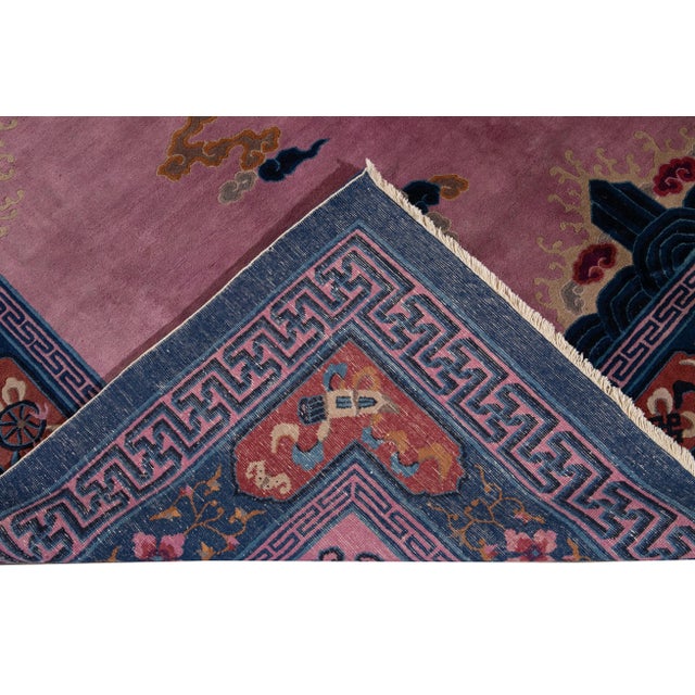 Beautiful Unique Antique Beijing hand-knotted Wool rug with a purple field. This Beijing rug has a blue frame and multi-...